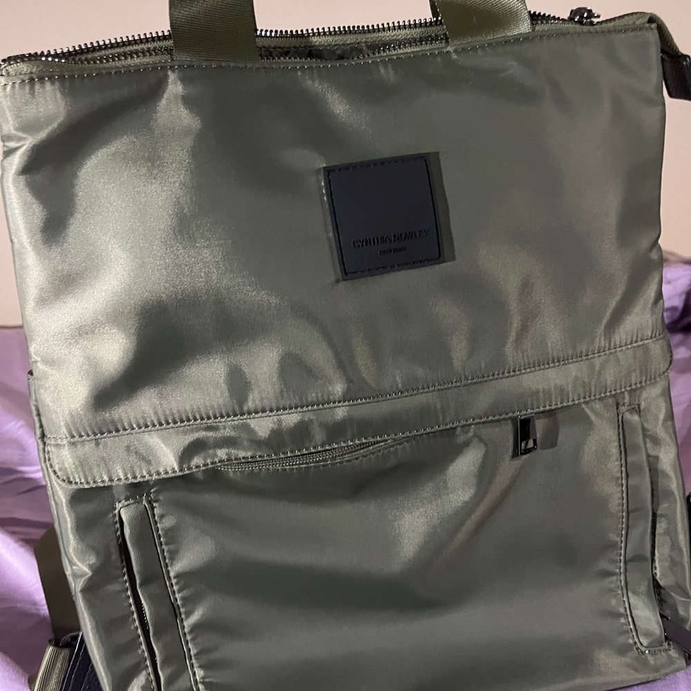 Green backpack.  Luggage sleeve.  Top handles.